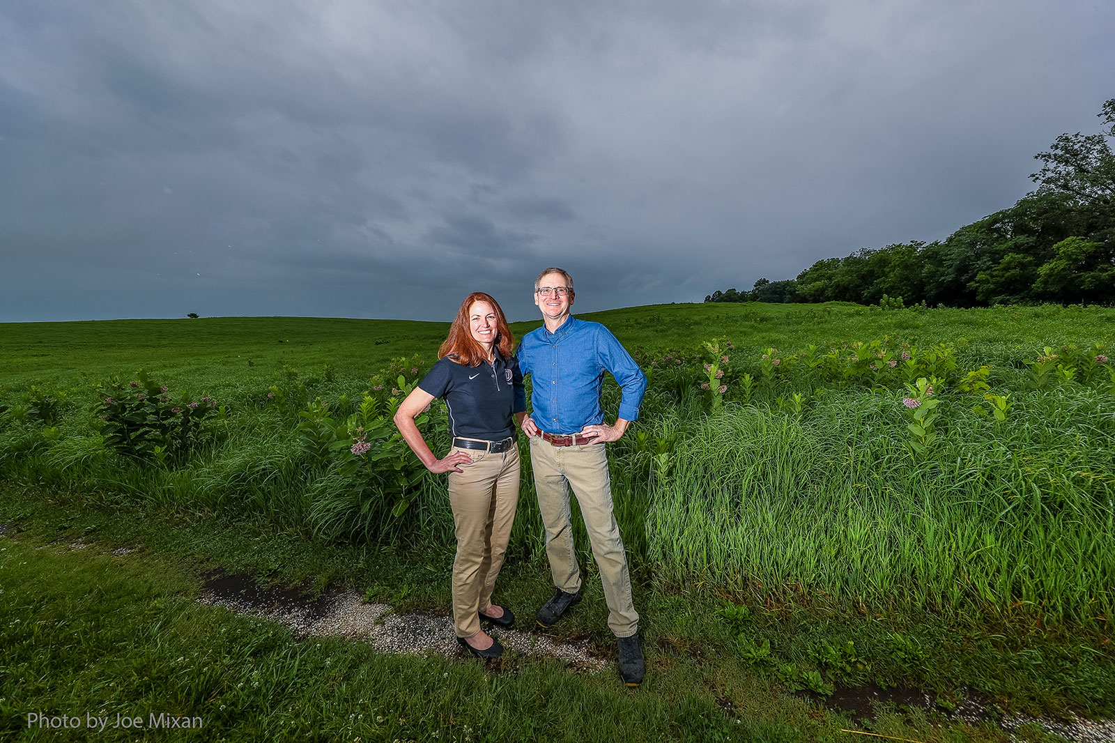 LaReesa Wolfenbarger and John P. McCarty stand in a green field.